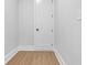 Hallway with clean white walls, modern trim, and wood-look flooring at 3312 Mill Forest Dr, Conyers, GA 30094