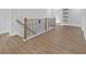 Hallway featuring wood floors, iron and wood railing, and white trim at 3312 Mill Forest Dr, Conyers, GA 30094