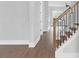 Bright hallway featuring hardwood floors, modern railings, and trim at 3312 Mill Forest Dr, Conyers, GA 30094
