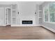 Bright living room featuring a modern fireplace, built-in shelving, and large windows for natural light at 3312 Mill Forest Dr, Conyers, GA 30094