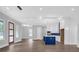 Bright open-concept space with modern lighting, many windows, and kitchen island with blue cabinets at 3312 Mill Forest Dr, Conyers, GA 30094