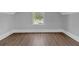 Bright, empty room with a window and hard wood floors at 3312 Mill Forest Dr, Conyers, GA 30094