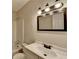 Well-lit bathroom features a white sink, dark hardware, and a framed mirror at 4384 Raven Valley Ct, Decatur, GA 30035