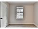 Bedroom featuring hardwood floors, a large window, and modern neutral paint at 4384 Raven Valley Ct, Decatur, GA 30035