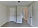 Bedroom with neutral walls, vinyl flooring, and open doorway at 4384 Raven Valley Ct, Decatur, GA 30035