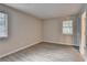 Bedroom with neutral paint, vinyl flooring, and two windows at 4384 Raven Valley Ct, Decatur, GA 30035