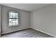 Bedroom featuring luxury vinyl plank flooring and natural light from one window at 4384 Raven Valley Ct, Decatur, GA 30035