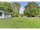 View of the front lawn with trees and greenery surrounding the property at 4384 Raven Valley Ct, Decatur, GA 30035