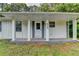 Inviting front porch with decorative stone accents and a covered entrance at 4384 Raven Valley Ct, Decatur, GA 30035