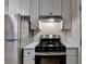 Kitchen featuring stainless steel appliances, white cabinets, and a marble countertop at 4384 Raven Valley Ct, Decatur, GA 30035