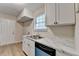 Well-lit kitchen featuring white cabinets, marble countertops, and stainless steel appliances at 4384 Raven Valley Ct, Decatur, GA 30035