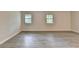 Spacious living room with modern flooring and ample natural light from the windows at 4384 Raven Valley Ct, Decatur, GA 30035