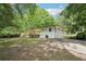 Backyard view featuring a spacious lawn, concrete pad and wooden deck at 5729 Jefferson Ave, Forest Park, GA 30297