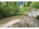 The backyard has an expansive lawn, a concrete pad, and a deck attached to house at 5729 Jefferson Ave, Forest Park, GA 30297