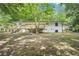The backyard features a freshly-stained deck, painted brick and a flat lot surrounded by mature trees at 5729 Jefferson Ave, Forest Park, GA 30297