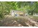 Backyard view with deck, painted brick and a flat lot surrounded by mature shade trees at 5729 Jefferson Ave, Forest Park, GA 30297