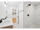 Bathroom featuring a double sink, shower, and a stylish design with a view into another room at 5729 Jefferson Ave, Forest Park, GA 30297