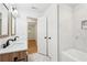 Bathroom with double sink vanity, framed mirrors, marbled floors, and a tub/shower combo with black fixtures at 5729 Jefferson Ave, Forest Park, GA 30297