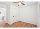 Clean, bright bedroom with wood floors and a ceiling fan, leading to an en-suite bathroom at 5729 Jefferson Ave, Forest Park, GA 30297
