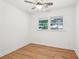 Bright bedroom featuring wood flooring, a ceiling fan and a large window looking out at the neighborhood at 5729 Jefferson Ave, Forest Park, GA 30297