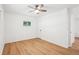 A bright bedroom has a ceiling fan, wood-look floors and a white closet door at 5729 Jefferson Ave, Forest Park, GA 30297