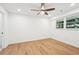 Bedroom features neutral walls, light wood floors, recessed lights, a ceiling fan, and a window at 5729 Jefferson Ave, Forest Park, GA 30297