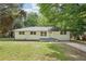 Charming painted brick home with a well-maintained lawn and mature trees at 5729 Jefferson Ave, Forest Park, GA 30297