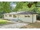Charming painted brick home with a well-maintained lawn and mature trees at 5729 Jefferson Ave, Forest Park, GA 30297