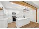 Bright kitchen featuring white cabinets, stainless appliances, island with seating, and pendant lighting at 5729 Jefferson Ave, Forest Park, GA 30297
