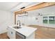 Open concept kitchen with a large island, stainless steel appliances, and a modern light fixture at 5729 Jefferson Ave, Forest Park, GA 30297