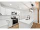 Bright kitchen featuring white cabinets, stainless appliances, island with seating, and pendant lighting at 5729 Jefferson Ave, Forest Park, GA 30297