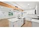 Open concept kitchen with a large island, stainless steel appliances, and a modern light fixture at 5729 Jefferson Ave, Forest Park, GA 30297
