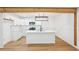 Bright kitchen featuring white cabinets, stainless appliances, island with seating, and pendant lighting at 5729 Jefferson Ave, Forest Park, GA 30297