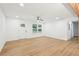 Bright living room featuring light wood flooring, white walls, ceiling fan, and recessed lights at 5729 Jefferson Ave, Forest Park, GA 30297