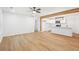Open-concept living room with light wood flooring connected to modern kitchen with island at 5729 Jefferson Ave, Forest Park, GA 30297