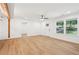 Bright living room featuring light wood flooring, white walls, ceiling fan, and recessed lights at 5729 Jefferson Ave, Forest Park, GA 30297