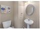 Powder room with pedestal sink and modern mirror at 971 Reap Lane, Lawrenceville, GA 30043