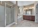 Bright bathroom featuring a glass enclosed shower, soaking tub, and double vanity with granite countertops at 971 Reap Lane, Lawrenceville, GA 30043