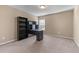 A carpeted bedroom features a built-in desk and shelving near a bright window at 971 Reap Lane, Lawrenceville, GA 30043