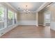 Bright dining area with large windows, light wood flooring, and decorative chair rail at 971 Reap Lane, Lawrenceville, GA 30043