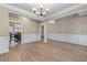Open-concept dining area with wood floors, stylish light fixtures, and elegant trim at 971 Reap Lane, Lawrenceville, GA 30043