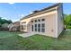 The rear of the home features a concrete patio, a lawn and many windows at 971 Reap Lane, Lawrenceville, GA 30043