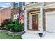 Inviting front entryway with a classic wood door, stone accents, and meticulous landscaping at 971 Reap Lane, Lawrenceville, GA 30043