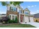 Charming two-story home showcasing a stone facade, a two-car garage, and manicured landscaping at 971 Reap Lane, Lawrenceville, GA 30043