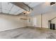A two car garage features a concrete floor and shelving for storage at 971 Reap Lane, Lawrenceville, GA 30043