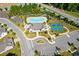 An aerial view of community pool, clubhouse, tennis courts, and garden plots at 704 Chipping Sparrow St, Canton, GA 30115