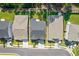 Aerial view of home outlined on neighborhood street with pristine landscaping at 704 Chipping Sparrow St, Canton, GA 30115