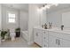 Well-lit bathroom featuring double vanity, tile flooring and tub-shower combination at 704 Chipping Sparrow St, Canton, GA 30115