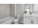 Bathroom features a tub-shower combo, toilet, and vanity with shaker-style cabinets at 704 Chipping Sparrow St, Canton, GA 30115