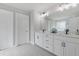 Bright bathroom features dual vanity with white cabinets, modern fixtures, and tile flooring at 704 Chipping Sparrow St, Canton, GA 30115